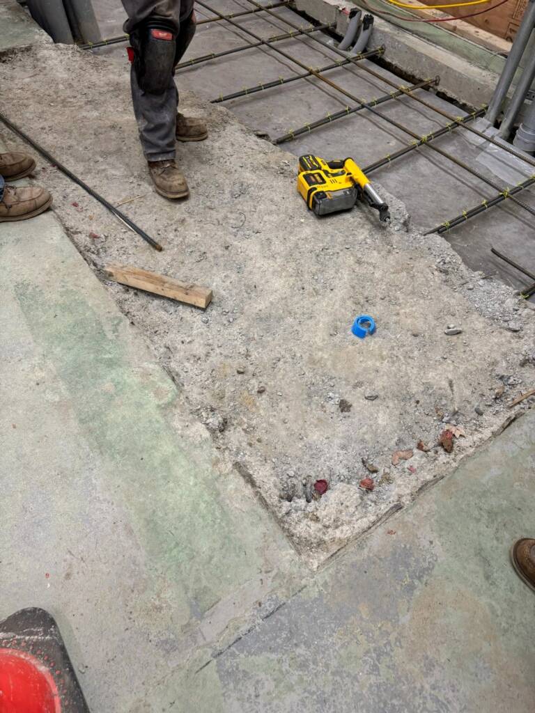 Rebar reinforcement installed during concrete slab repair for epoxy flooring