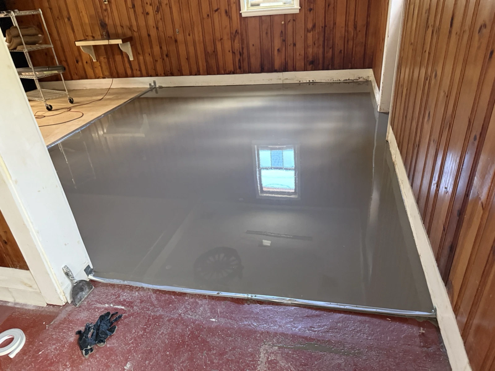 Finished self-leveling concrete floor ready for epoxy coating installation